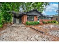 Charming single-story brick house with a cozy carport and well-maintained landscaping at 829 Burton St, Rocky Mount, NC 27803