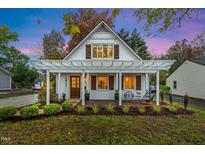 Charming home with a inviting front porch and beautiful landscaping, perfect for enjoying outdoor living at 1917 Washington St, Durham, NC 27704