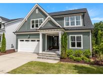 Charming two-story home with a beautiful lawn, inviting front porch, and a convenient attached two-car garage at 192 Logbridge Rd, Chapel Hill, NC 27516