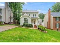 Charming two-story home features a well-manicured lawn, inviting front porch, and classic architectural details at 203 Lighthouse Way, Cary, NC 27511