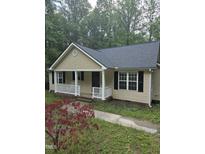Charming single-story home with a covered front porch and well-maintained landscaping, set among mature trees at 2122 Sterling Creek Ln, Franklinton, NC 27525