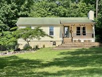 Charming single-story home with a welcoming front porch and a well-maintained lawn at 280 Sagamore Dr, Louisburg, NC 27549