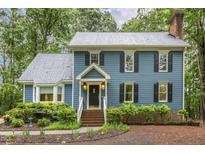 Charming two-story home with blue siding, black shutters, and a well-maintained landscaped front yard at 3420 Greenville Loop Rd, Wake Forest, NC 27587