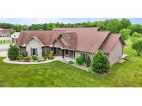 Beautiful single-story home with stone and wood facade, well-manicured lawn and landscaping at 3465 Covington Trl, Mebane, NC 27302