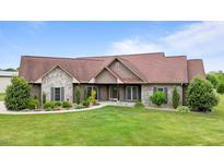 A charming single-story home boasts a well-manicured lawn, stone accents, and a welcoming entrance at 3465 Covington Trl, Mebane, NC 27302