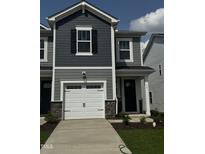 Charming two-story home featuring a white garage door, stone accents, and gray siding at 36 Twin Birch Dr, Angier, NC 27501