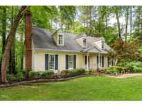 Charming home with manicured lawn,dormers, and mature landscaping providing an inviting curb appeal at 4 Barkridge Ct, Durham, NC 27713