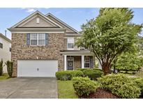 Charming brick home with a manicured front yard and a two-car garage at 4003 Jockey Club Cir, Cary, NC 27519