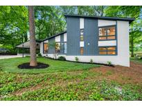 Charming updated home featuring a unique design and beautiful landscaped front yard, providing excellent curb appeal at 4012 Castle Ct, Raleigh, NC 27613