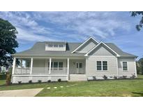 Charming, newly built home with a welcoming front porch and beautifully landscaped front yard at 4016 Berman Edge Rd, Holly Springs, NC 27540