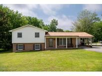 Charming two-story home with a well-manicured lawn and a welcoming front porch at 409 Ivey Rd, Graham, NC 27253