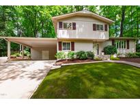 Charming two-story home with landscaped front yard and attached carport at 4213 Oak Park Rd, Raleigh, NC 27612