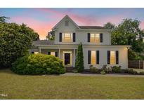 Charming two-story home with manicured lawn and lush landscaping at 6521 Cablewood Dr, Raleigh, NC 27603