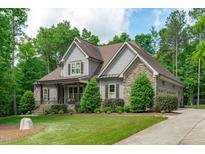 Beautiful craftsman style home with stone accents, neutral siding and manicured landscaping in a desirable neighborhood at 677 Juliette Ct, Creedmoor, NC 27522