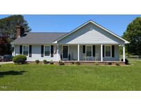 Charming single-story home with a welcoming front porch and well-manicured lawn at 940 Pamela Ln, Rocky Mount, NC 27803