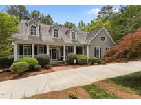 Charming home featuring a meticulously landscaped front yard, inviting entrance, and classic architectural details at 1009 Bearglades Ln, Raleigh, NC 27615
