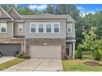 Charming townhome featuring a two-car garage and tasteful stone accents on the facade at 1022 Flagler St, Durham, NC 27713
