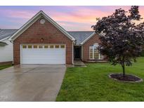Charming brick home featuring a two-car garage, well-manicured lawn, and attractive landscaping at 103 Rama Ct, Morrisville, NC 27560