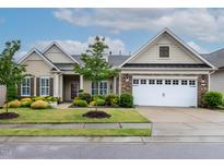 Charming single-Gathering home with a manicured lawn and attached two-car garage at 112 Tanoak Ct, Durham, NC 27703