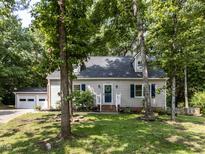 Charming exterior view of the home featuring blue shutters and a well-maintained front yard at 113 Honeysuckle Ln, Durham, NC 27703