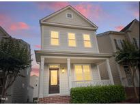 Charming two-story home features a welcoming porch and manicured landscaping at 113 Windy Creek Ln, Apex, NC 27502