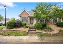 Charming brick and stone home with inviting front garden and well-maintained landscaping at 11340 Involute Pl # 100, Raleigh, NC 27617