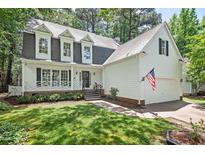 Charming two-story home with a white picket fence and well-manicured lawn at 115 Nuttree Way, Durham, NC 27713