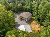 Expansive aerial view of home surrounded by dense green trees at 121 Pheasant Ct, Pittsboro, NC 27312