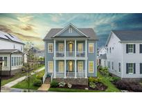 Charming two-story home featuring double balconies, a beautifully landscaped yard, and classic architectural details at 1423 Tannin Dr, Durham, NC 27713