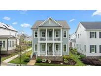 Charming two-story home featuring a double front porch and landscaped front yard at 1423 Tannin Dr, Durham, NC 27713