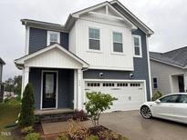 Charming two-story home featuring a two-car garage, landscaped yard, and inviting front porch at 159 Wood Orchid Ln, Garner, NC 27529