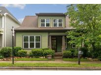 Charming two-story home with a well-manicured lawn and beautiful landscaping at 1930 Briar Chapel Pkwy, Chapel Hill, NC 27516