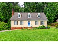 Charming two-story home with dormer windows and a well-manicured front lawn at 210 Dutchess Dr, Cary, NC 27513