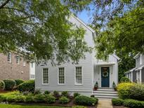 Charming two-story home with light-colored siding, lush landscaping, and a welcoming front entrance at 2309 Yancey St, Raleigh, NC 27608