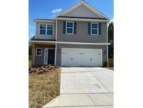 Charming two-story home with gray siding, a two-car garage, and a well-manicured lawn at 261 Plains Dr # 263, Burlington, NC 27217