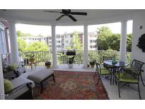 Inviting outdoor patio featuring elegant columns, comfortable seating, and scenic neighborhood views at 2901 Market Bridge Ln # 203, Raleigh, NC 27608