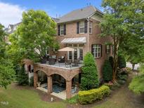 Stunning brick home with a large balcony overlooking lush landscaping, perfect for outdoor entertaining and relaxation at 2921 Imperial Oaks Dr, Raleigh, NC 27614