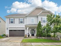 Charming two-story home with a well-manicured lawn, inviting curb appeal, and a two-car garage at 316 Wellwater Ave, Durham, NC 27703