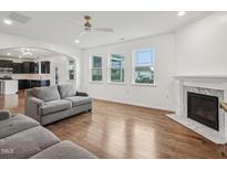 Bright living room features hardwood floors, a fireplace, and large windows at 316 Wellwater Ave, Durham, NC 27703
