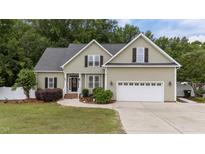 Charming single-Gathering home with a well-manicured lawn, two-car garage, and inviting curb appeal at 3216 Nc Hwy 42, Willow Springs, NC 27592
