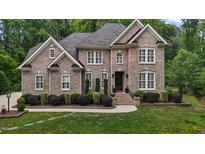Beautiful brick home with well-manicured landscaping and a welcoming front entrance at 3323 Cheswick Dr, Raleigh, NC 27609