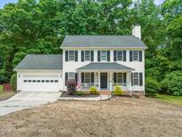 Charming two-story home with a covered porch and well-manicured lawn at 3401 Sitzman Ct, Raleigh, NC 27616