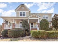 Charming two-story home with a large front porch and well-manicured landscaping at 405 Challenge Rd, Raleigh, NC 27603
