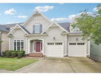 Charming gray home with a red front door and a two-car garage at 4125 Enfield Ridge Dr, Cary, NC 27519