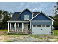 Charming two-story home boasting a two-car garage and stone accents in a well landscaped community at 4167 Old Stage N Rd # 4, Angier, NC 27501