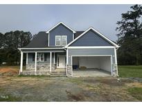 New construction home featuring stone accents, a two-car garage, and a covered front porch at 4167 Old Stage N Rd # 4, Angier, NC 27501