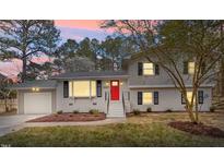 Charming two-story home featuring a bright red front door and well-maintained landscaping at 4307 Pope Rd, Durham, NC 27707