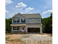 New two-story home featuring light gray siding, black shutters, and an attached two-car garage at 50 Moonraker Dr, Spring Hope, NC 27882