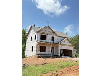 New construction home with builder's wrap, showcasing its framing and potential at 50 Moonraker Dr, Spring Hope, NC 27882