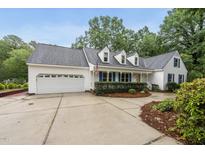 Charming home boasts a well-manicured lawn, attached two-car garage, and inviting curb appeal at 5513 Doemont Dr, Apex, NC 27539